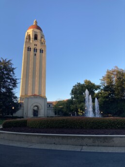 Sunlight shines on a tall tower at Stanford University Campus